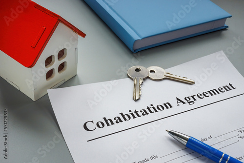 Cohabitation agreement, keys and model of home. photo
