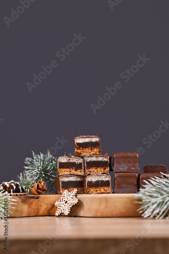 Halved taditional German sweets called 'Dominosteine'. Christmas candy consisting of gingerbread, jelly and marzipan layers covered with chocolate icing photo