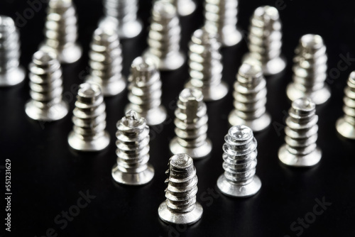 A group of Small bolts for computer equipment and computer assembly on black background