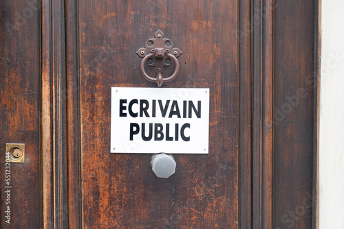 ecrivain public french panel text means Public letter writer sign on wooden door in France photo