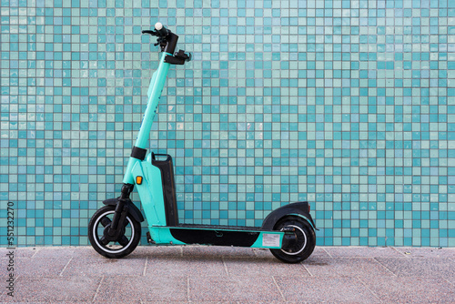 Canvas Print electric scooter of a Scooter sharing system parked on a sidewalk in front of a