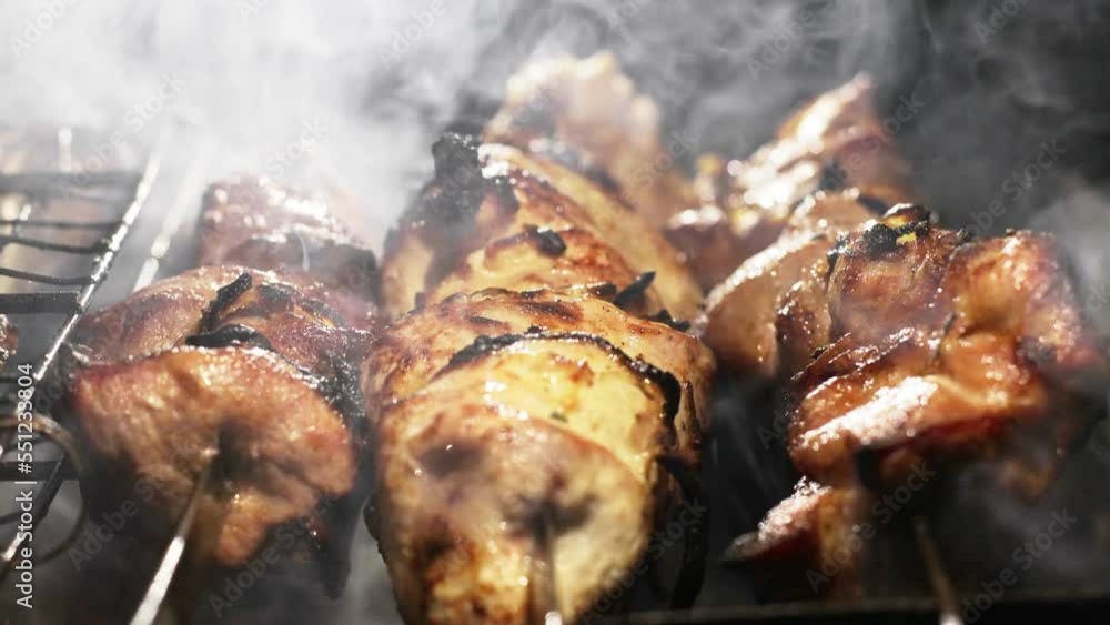 Cooking a juicy pork kebab on skewer on the grill, barbecue. Cooking a juicy pork kebab on skewer on the grill, barbecue.