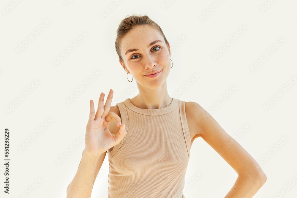 Pretty charming cute young caucasian student girl showing ok sign on white studio background, happy youthful female giving excellent feedback on services or assuring everything is under control Pretty charming cute young caucasian student girl showing ok sign on white studio background, happy youthful female giving excellent feedback on services or assuring everything is under control