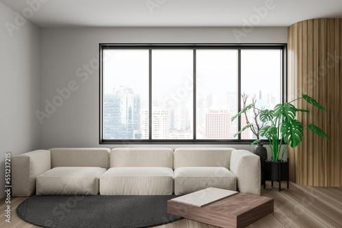 Stylish relaxing interior with couch and coffee table, panoramic window © ImageFlow