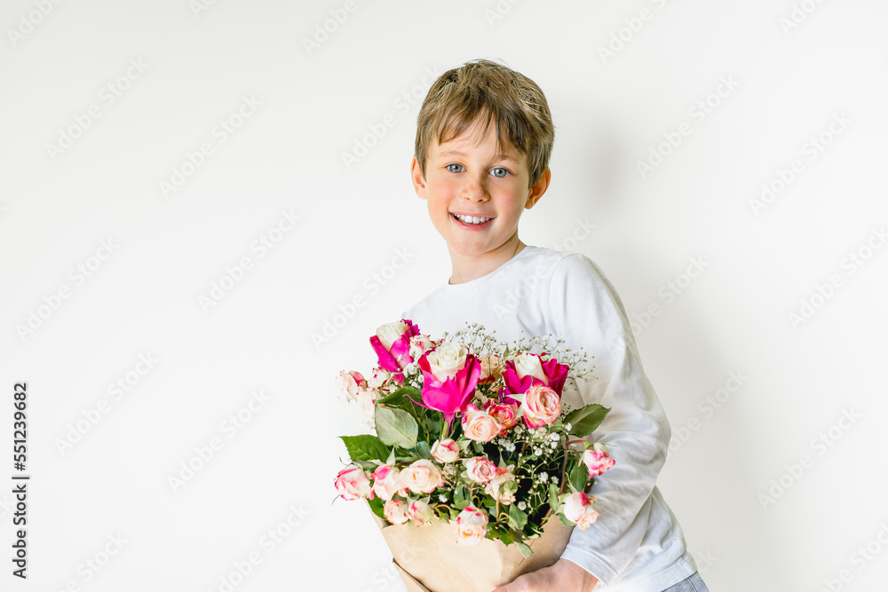 Joyful white caucasian boy 9 years old with a bouquet of flowers is ready to congratulate you! Copy space for your text Joyful white caucasian boy 9 years old with a bouquet of flowers is ready to congratulate you! Copy space for your text