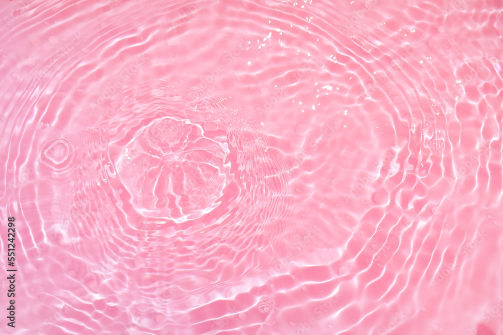 Defocus blurred transparent pink colored clear calm water surface texture with splashes and bubbles. Trendy abstract nature background. Water waves in sunlight with copy space. Pink watercolor shining Defocus blurred transparent pink colored clear calm water surface texture with splashes and bubbles. Trendy abstract nature background. Water waves in sunlight with copy space. Pink watercolor shining