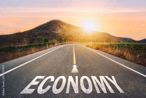 Wallpaper Mural Economy written on asphalt road in sunset concept of goals and challenges or career path success business opportunity and change. Torontodigital.ca