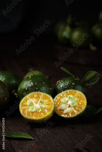 close up of Slices of lime on old wooden surface