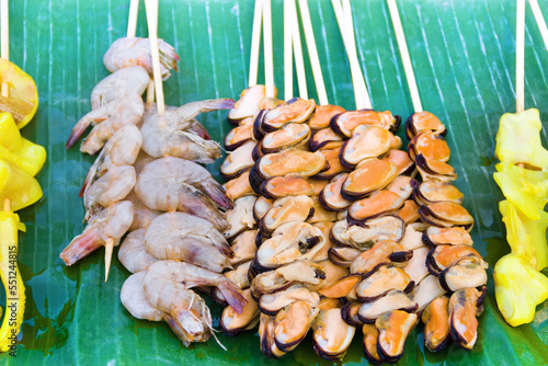 Thai cuisine, exotic food. Grilled young octopuses, shrimp and shellfish photo