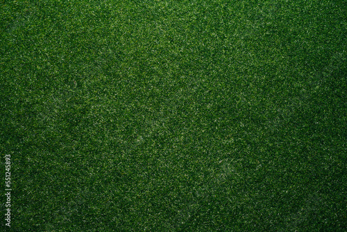 Top view of artificial grass texture of deep green. Simulating short trimmed lawn