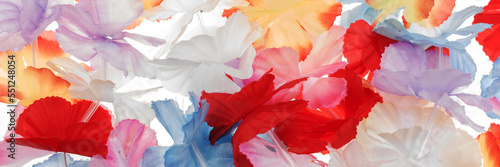 Colorful panoramic background. Colorful plastic hawaii flowers