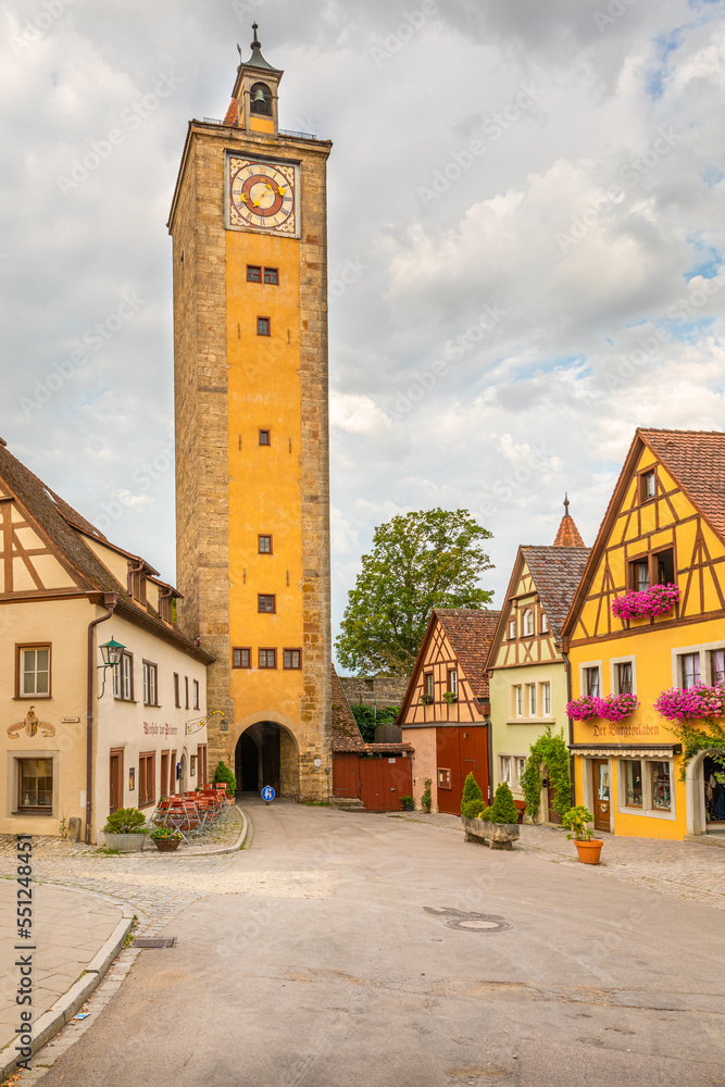 Castle tower and city gate at the entrance to the garden, one of the most beautiful and romantic villages in Europe, Rothenburg ob der Tauber, Germany.
