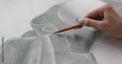 Girl draws a pencil sketch on paper. The concept of creativity, painting, fine art, graphics and design. Drawing lessons. 4K 4096x2160