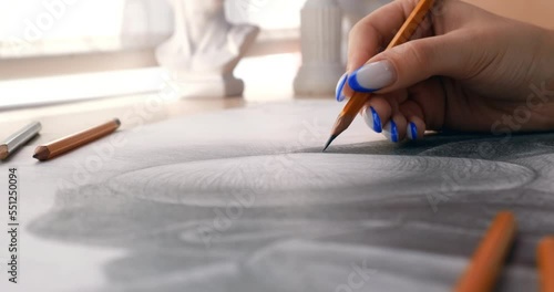 Girl draws a pencil sketch on a piece of paper. Student of the art school makes a pencil sketch. The concept of creativity, painting, hobby. 4K 4096x216