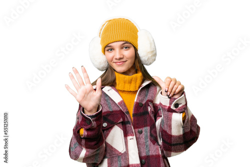 Teenager caucasian girl wearing winter muffs over isolated background counting six with fingers