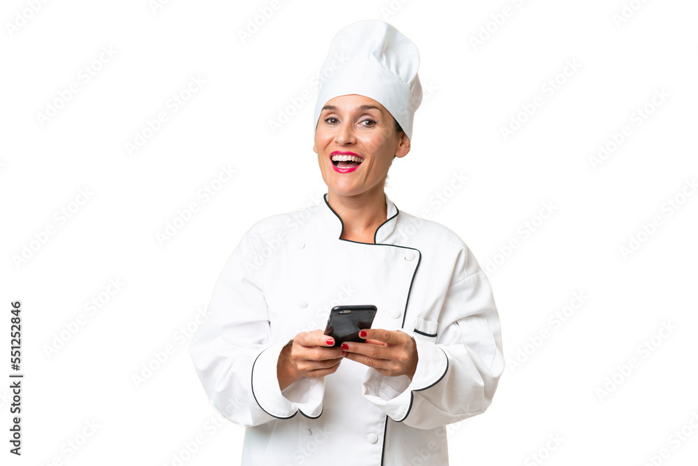 Middle-aged chef woman over isolated background surprised and sending a message