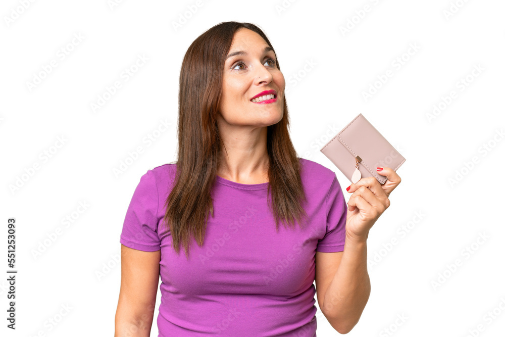 Middle-aged caucasian woman holding a wallet over isolated background looking up while smiling Middle-aged caucasian woman holding a wallet over isolated background looking up while smiling