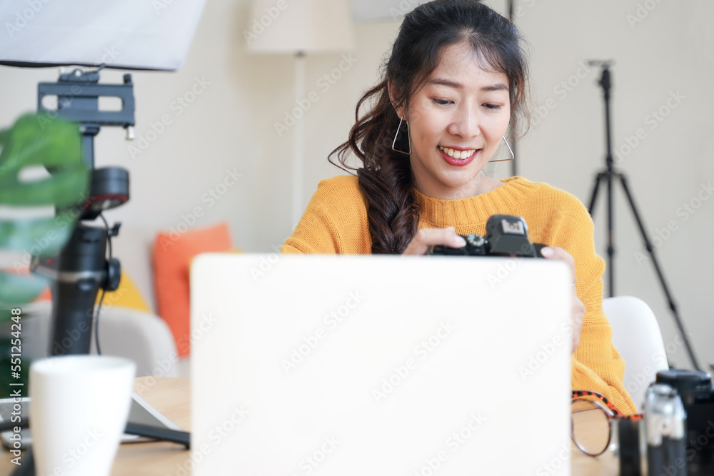Lifestyle Asia young women photographer and freelance holding a dslr camera in home office. Female photographer smiling cheerfully working new project in studio Lifestyle Asia young women photographer and freelance holding a dslr camera in home office. Female photographer smiling cheerfully working new project in studio