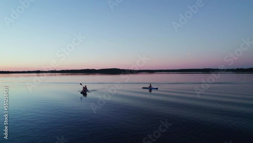 Wallpaper Mural Woman with children sit and paddle on inflatable sup boards on a lake. Low angle view. orbit shot. Active summer vacation during midsummer blue hour. Näs bruk, Dalarna Sweden Torontodigital.ca