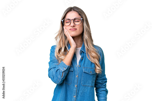 Young Uruguayan woman over isolated background with toothache photo