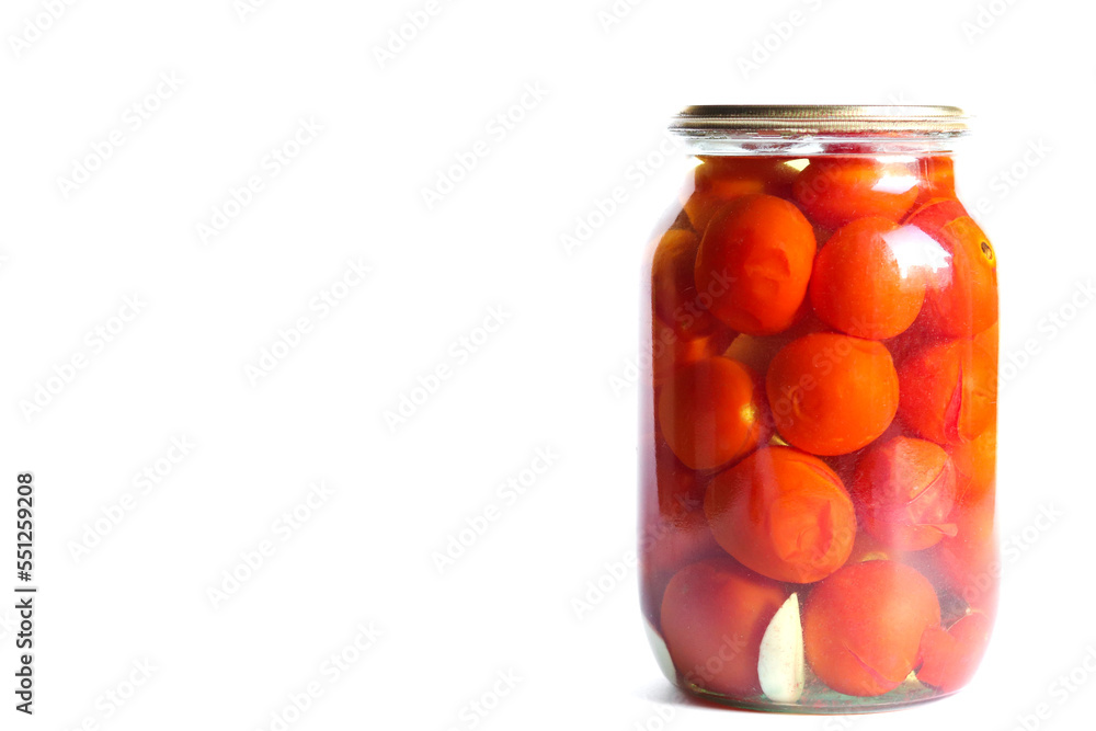 Pickled tomatoes in glass jar isolated on a white background. Space for text. Pickled tomatoes in glass jar isolated on a white background. Space for text.