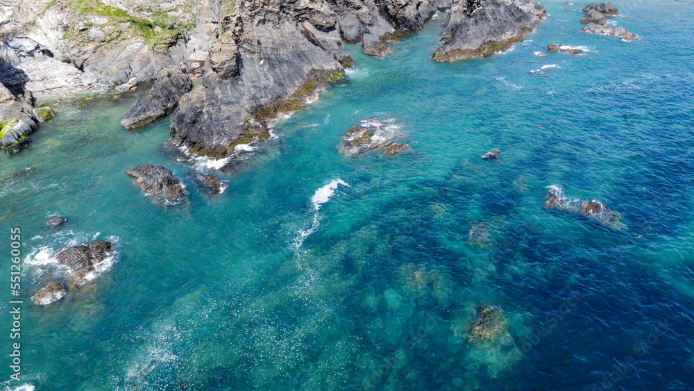 Steep cliffs on the southern coast of Ireland. Turquoise waters of the Atlantic Ocean. Natural beauties of Ireland, West Cork. The rocky coast of the Celtic Sea. Drone point of view.