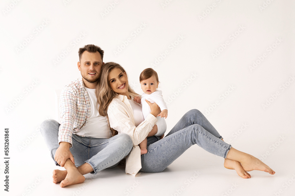 family portrait on a white background, happy family concept portrait. the parents play with the child. family portrait on a white background, happy family concept portrait. the parents play with the child.