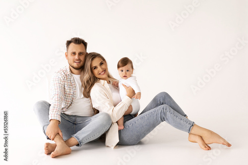 family portrait on a white background, happy family concept portrait. the parents play with the child.