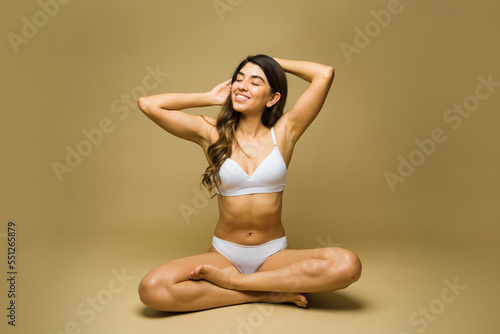 Relaxed latin woman smiling wearing underwear