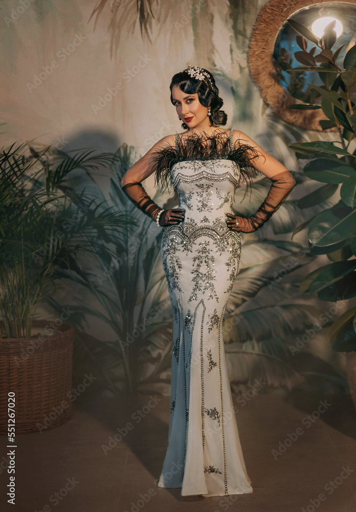 Sexy elegant flapper woman in old style silver retro long evening dress ...