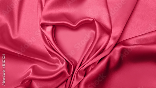 Viva Meganta toned red fabric atlas. Pink silk satin texture. Abstract background wallpaper Valentine's Day, February 14th. Twisted folds cloth heart shape sign. Trendy color of the year 2023. 

 photo