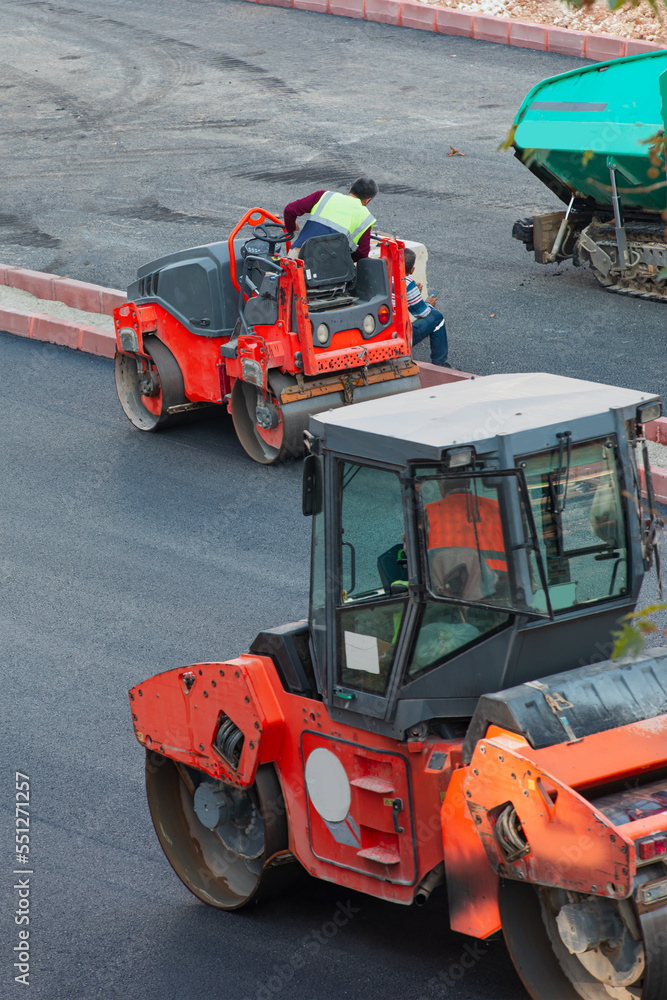 Road roller at construction site - Construction site is laying new asphalt road pavement Road roller at construction site - Construction site is laying new asphalt road pavement