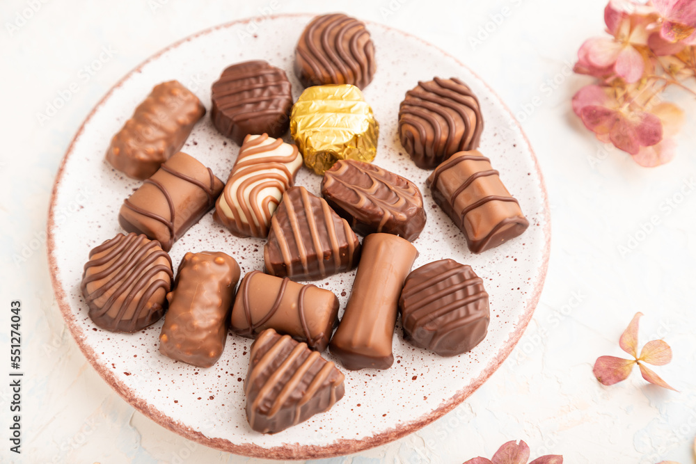 Chocolate candies with cup of coffee. side view, selective focus.