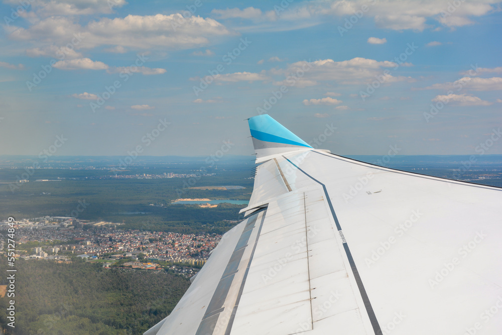 View from an aircraft window shortly after take-off with a view of the wing and landscape from the Frankfurt am Main area, Germany