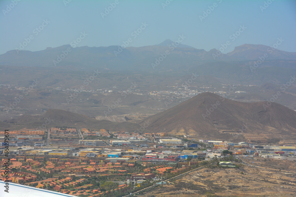 View from an airplane window during the landing approach over the island of Tenerife to Reina Sofía Airport