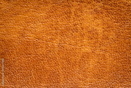 Brown artificial or synthetic leather background with neat texture and copy space