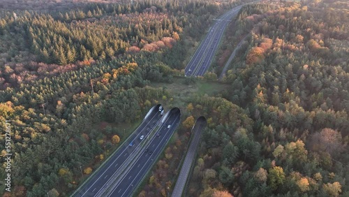 Ecoduct, ecopassage, nature bridge or game changeover. Infrastructure structure for animals and other wildlife to cross traffic, passage over a highway. Nature and man made objects merge. photo