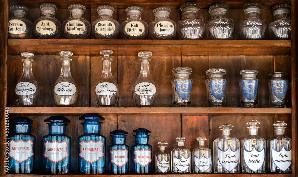 Bottles with drugs from old medical, chemical and pharmaceutical glass. Chemistry and pharmacy history concept background. Retro style. Chemical, drugstore and apothecary substances.