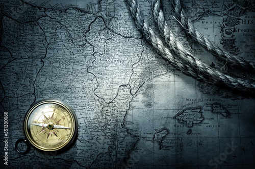 Magnetic old compass on world map. Travel, history, geography, navigation, tourism and exploration concept background.