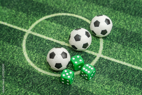 dice and soccer ball on green grass  football sports betting concept