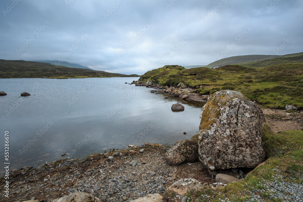 Pasture with a lake in a mountain valley