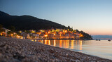 tourist resort Moscenicka Draga, illuminated in the evening. view from the beach