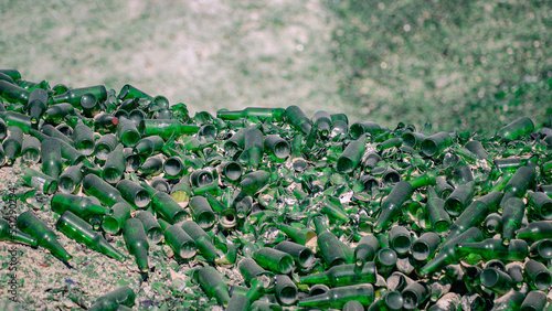 Green glass bottles in the trash