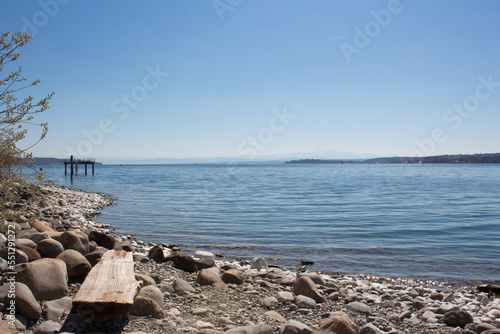 Rocks and a wooden bench at Lake Constance, Germany © dagascht