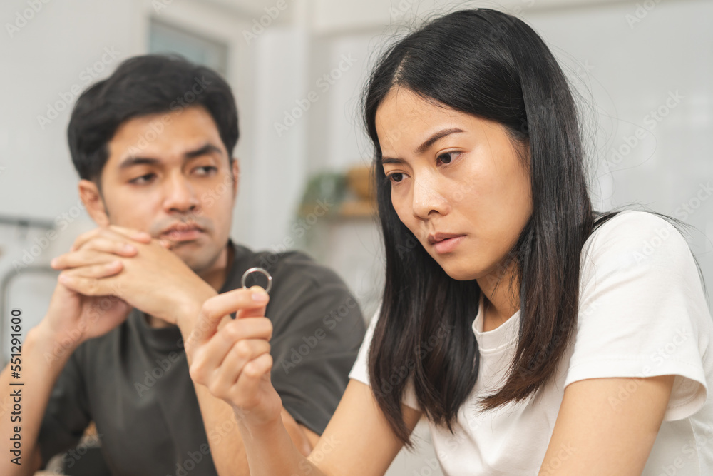 Stress, unhappy asian young couple man, woman quarrel, relationship in trouble. Fight wife holding wedding ring in disappointment and upset her husband, which may lead to divorce. Problem of family. Stress, unhappy asian young couple man, woman quarrel, relationship in trouble. Fight wife holding wedding ring in disappointment and upset her husband, which may lead to divorce. Problem of family.