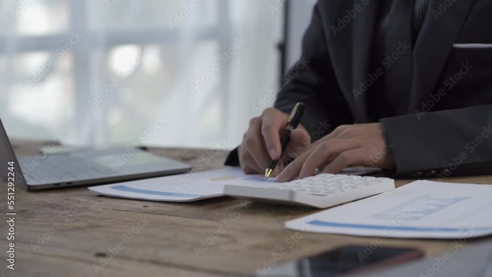 Accountant working in the office, counting profits, taxes, routine documents, analyzing statistics on financial reports with laptop computer. Accountant working in the office, counting profits, taxes, routine documents, analyzing statistics on financial reports with laptop computer.