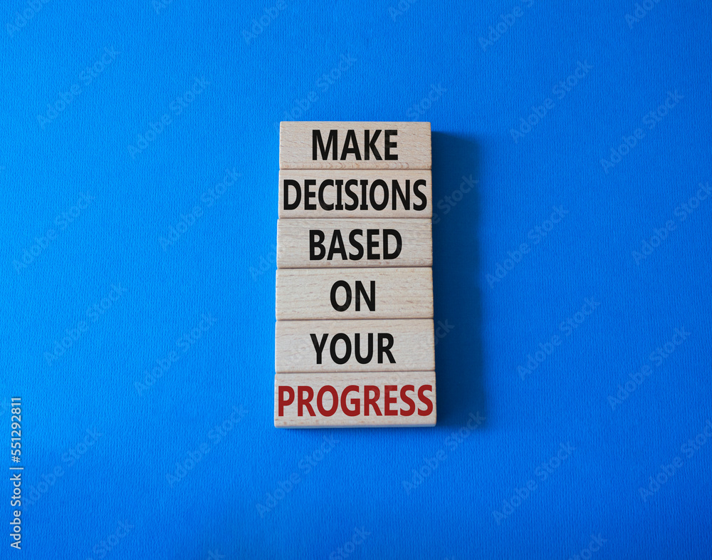 Decision and Progress symbol. Concept words Make decisions based on your progress on wooden blocks. Beautiful blue background. Business and decision and progress concept. Copy space. Decision and Progress symbol. Concept words Make decisions based on your progress on wooden blocks. Beautiful blue background. Business and decision and progress concept. Copy space.