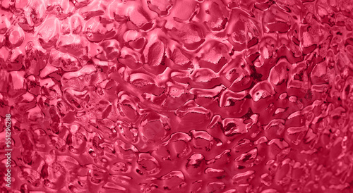 Abstract Magenta Background of uneven convex glass texture with ripple effect  water or ice imitation. Color of the year 2023
