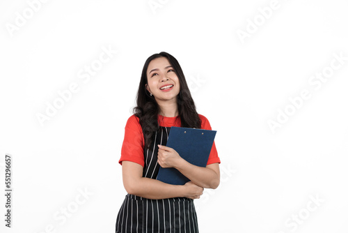 Holding clipboard, Food shop owner concept, Smiling young confident asian woman in black apron and red t-shirt isolated on white background.