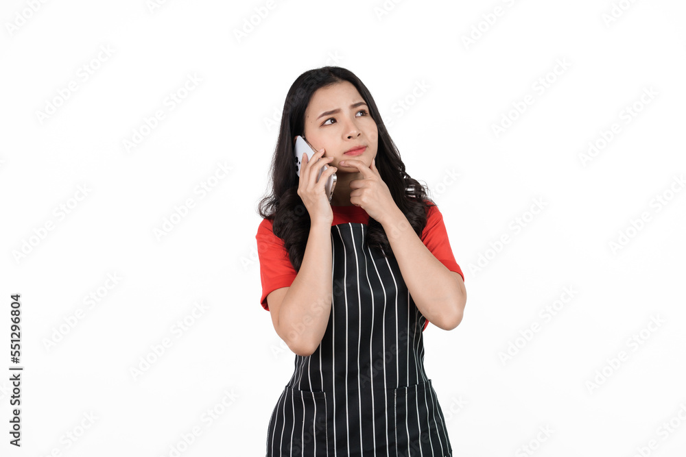 Call mobile phone, Food shop owner concept, Smiling young confident asian woman in black apron and red t-shirt isolated on white background. Call mobile phone, Food shop owner concept, Smiling young confident asian woman in black apron and red t-shirt isolated on white background.